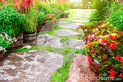 BeautifulÃƒÆ’Ã¢â‚¬Å¡Ãƒâ€šÃ‚Â garden and stone path and blooming flower and tree with green leaves Stock Photo